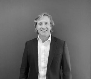 Andrew Perryman, founder of Bright Advice, smiles for a black and white portrait