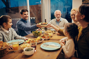 Multiple generations of a family sitting around the dinner table.