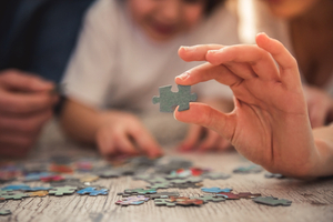 A group of people putting together a jigsaw.